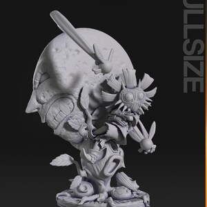 May include: A detailed, gray sculpture of a character from a video game. The sculpture features a large, moon-like face with a menacing expression, a mask, and a tree-like base. The word "FULLSIZE" is printed vertically on the right side.