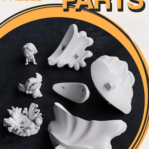 May include: Seven white 3D-printed chibi parts are arranged on a dark surface. The parts include a small figure, a character with large ears, and several abstract shapes. The word "PARTS" is displayed in large, bold letters.