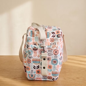 Side view of the large tote pattern showcasing the adjustable crossbody shoulder strap and handy side pockets.