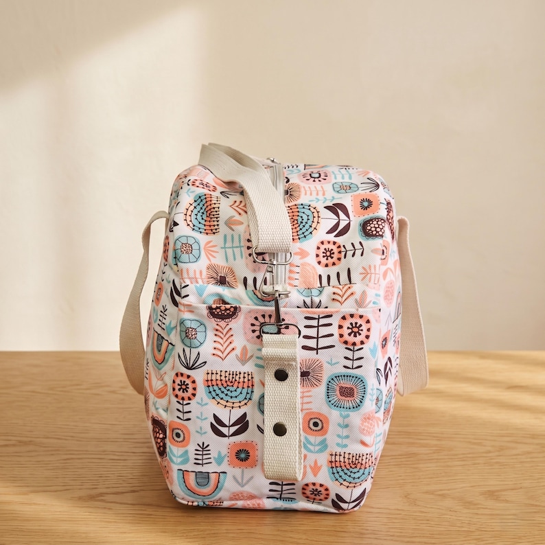 Side view of the large tote pattern showcasing the adjustable crossbody shoulder strap and handy side pockets.