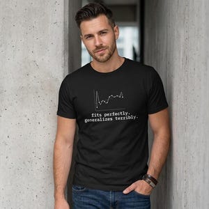 May include: A black short-sleeved t-shirt featuring a white line graph graphic and the text "fits perfectly. generalizes terribly." printed on the chest. The shirt has a crew neckline and a standard fit, constructed from a solid black fabric.