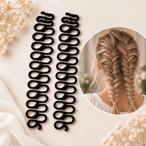 May include: Two black plastic hair braiding tools with a repeating looped design. The tools are shown alongside a circular inset image displaying a person with blonde hair styled into two neat fishtail braids using the braiding accessories.