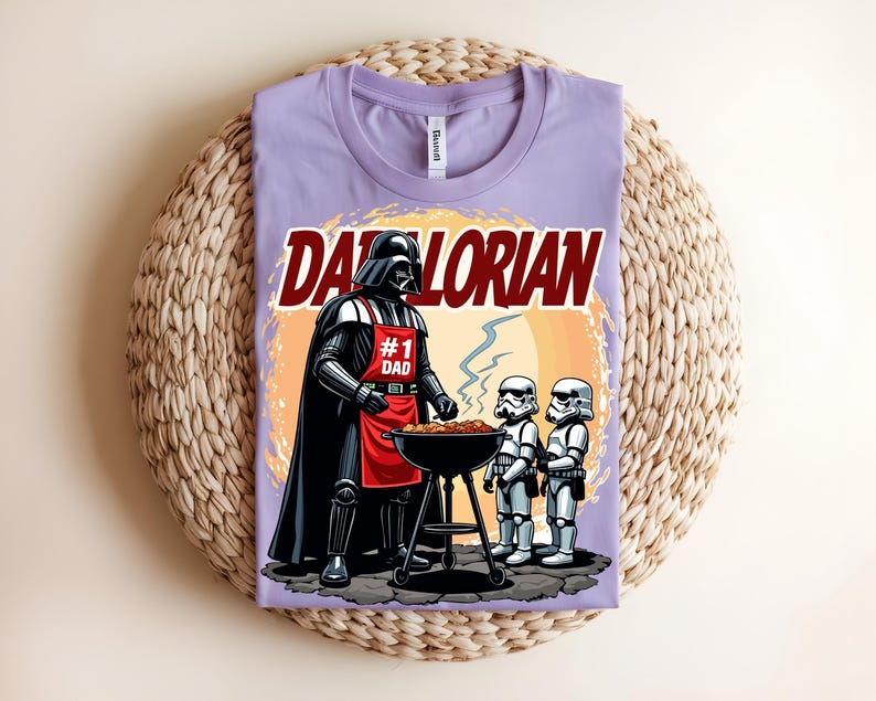 May include: A lilac t-shirt with a graphic of Darth Vader grilling with Stormtroopers. The text "Darthlorian" is above the image, and Darth Vader wears a red apron that says "#1 Dad".