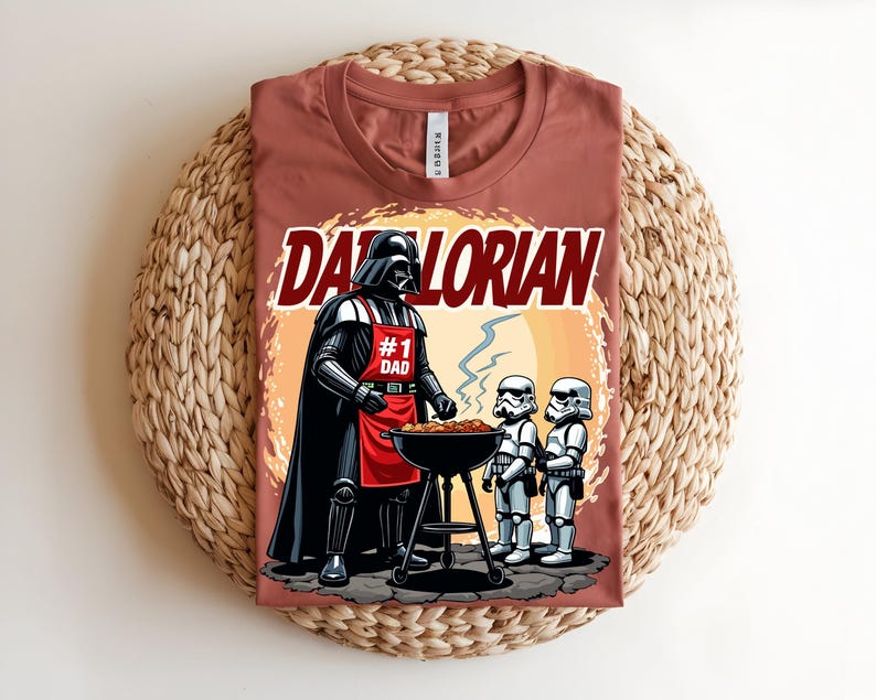 May include: A terracotta t-shirt with a graphic of Darth Vader wearing an apron that says "#1 Dad" grilling with two Stormtroopers. The text "Darthlorian" is above the image.