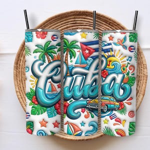 May include: Three cylindrical tumblers with black straws featuring a white background and a colorful graphic print. The design includes the word Cuba in large blue script, palm trees, sailboats, a vintage car, tropical flowers, and flags.