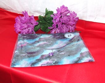 A vibrant galaxy‑print canvas book sleeve with a secure button closure.