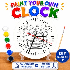 May include: A DIY clock kit with a white clock face featuring a birthday cake design. The clock has black hands and a red second hand. The kit includes paint pots, a paintbrush, and a stand. Text on the clock reads "HAPPY BIRTHDAY". The text "PAINT YOUR OWN CLOCK" is at the top.