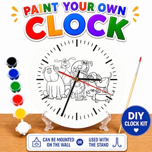 May include: DIY clock kit with a white clock face featuring a black and white dog illustration. The clock has black hands and a red second hand. The kit includes paint pots in various colors and a paintbrush. Text on the clock reads "PAINT YOUR OWN CLOCK".