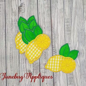 May include: Appliqué lemon designs with green leaves and yellow gingham details. One design features three lemons, and the other has two. The text "Junebug Appliques" is in the lower left corner.
