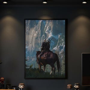 May include: A framed vertical wall art print depicting a figure with long white hair riding a brown horse, viewed from behind. The rider carries two swords on their back, facing a large stone fortress nestled against towering, snow-capped mountains.