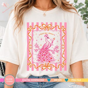May include: Cream-colored t-shirt featuring a pink and orange graphic. The graphic includes a peacock holding a cocktail, the text "bird day cheers," and a decorative frame with bows. The words "Digital Download," "300 DPI," and "PNG File" are also present.