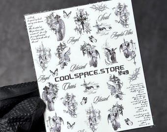 May include: A white rectangular sheet of black ink nail art decals featuring various gothic-style illustrations of angels, crosses, butterflies, and eyes. The text includes "COOLSPACE.STORE", "No.49", "Angel", "Soul", "Blessed", "Chaos", and "Angelic Vibes".