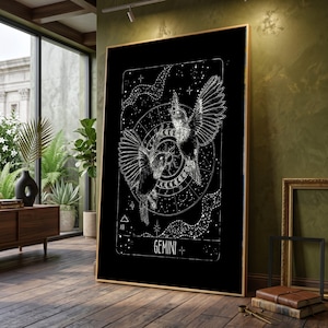 May include: Black framed art print featuring a detailed white illustration of two hummingbirds with outstretched wings, set against a backdrop of celestial elements and zodiac symbols. The word "GEMINI" is displayed at the bottom.