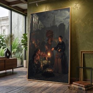 May include: A framed painting of a nighttime market scene, lit by candlelight. The artwork shows figures in a town square, including a woman in a dark dress and a basket on her head. The painting is displayed in a room with wooden flooring.