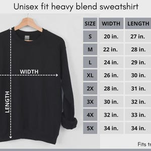 May include: A black long-sleeve sweatshirt with a crew neckline. The image includes a sizing chart labeled Unisex fit heavy blend sweatshirt, displaying width, length, and sleeve measurements in inches for sizes S through 5X, ranging from 20 to 40 inches.