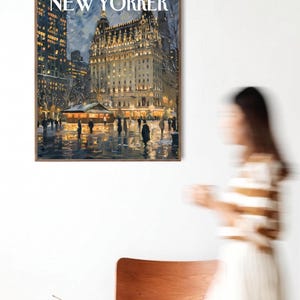 May include: A framed print of a vintage New Yorker cover from December 12, 1953, depicting a nighttime scene of a city street with illuminated buildings and figures. The print is displayed on a white wall.