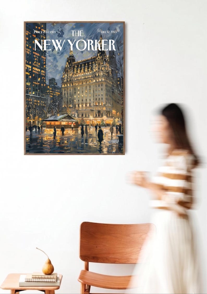 May include: A framed print of a vintage New Yorker cover from December 12, 1953, depicting a nighttime scene of a city street with illuminated buildings and figures. The print is displayed on a white wall.