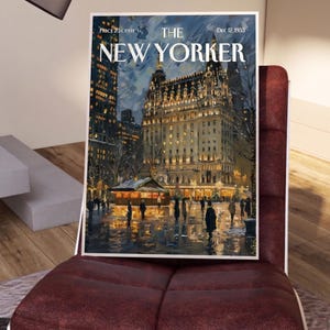 May include: A framed vintage cover of The New Yorker magazine, dated December 12, 1953, depicting a nighttime scene of a building with lights and people. The magazine is displayed on a burgundy chair.