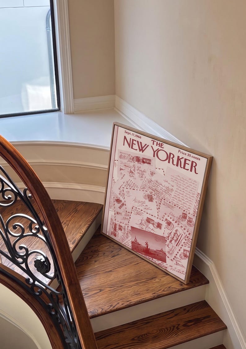 May include: A framed vintage New Yorker magazine cover from Sept. 17, 1966, in a wooden frame. The cover features a red and white design with illustrations and text. The framed print is leaning against a staircase.