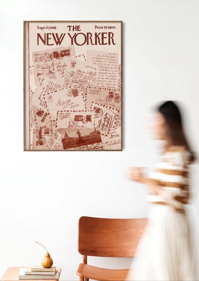 May include: A framed vintage New Yorker magazine cover from September 17, 1966, with a sepia-toned illustration of letters and stamps. The magazine cover is displayed on a white wall, with a blurred figure in the background.