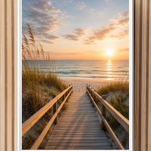 May include: A framed wall art print featuring a wooden boardwalk leading towards a sandy beach at sunset. The scene includes tall beach grass along the dunes, a calm ocean with gentle waves, and a soft orange and blue sky with scattered clouds.