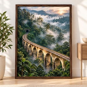 May include: A framed wall art print depicting a stone railway viaduct with multiple arches curving through a lush, misty tropical forest at sunrise. The scene features a dark tunnel entrance, dense green foliage, and soft golden sunlight.
