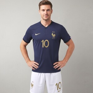 Pode incluir: Camisola de futebol azul marinho com detalhes dourados, com o n&uacute;mero 10 e um emblema de galo. A camisola tem decote em V e mangas curtas. Cal&ccedil;&otilde;es brancos com o n&uacute;mero 10 completam o conjunto.