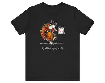 May include: A black t-shirt featuring a colorful, sketchy illustration of a turkey looking at a calendar page marked NOV 9 with a red circle. Below the graphic, the text reads by Nigel, aged 6 1/2 in a handwritten white font style.