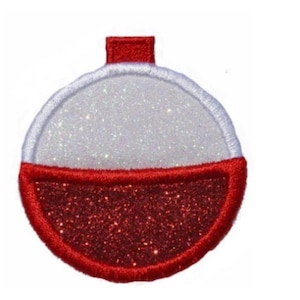 May include: A circular embroidered patch featuring a fishing bobber design. The top half is white with a glittery texture, while the bottom half is red with a glittery finish. The entire shape is outlined in red thread with a small tab at the top.