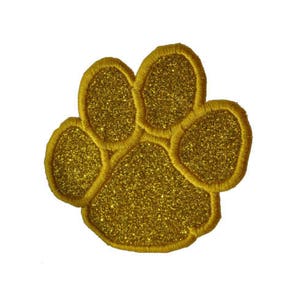 Peut inclure: Patch thermocollant en forme de patte d'animal en paillettes dorées.