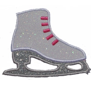 May include: A silver glitter ice skate with pink laces. The skate has a traditional design with a blade and a boot.