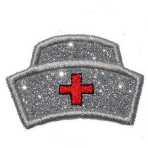 May include: A silver glitter nurse's hat with a red cross in the center.