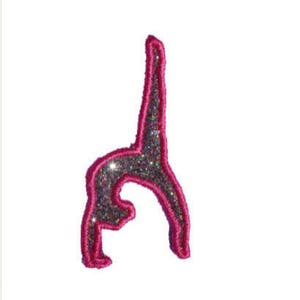 May include: Pink glitter iron-on patch of a gymnast doing a backbend.