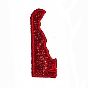May include: Red glitter outline of the state of Delaware.