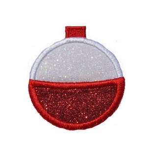 Pode incluir: Um bóia de pesca vermelho e branco com glitter e uma parte superior vermelha.