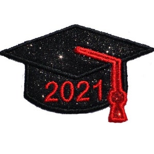 May include: A black glitter graduation cap with a red tassel and the year "2021" embroidered in red. The cap is square-shaped with a shiny, textured appearance, perfect for celebrating a graduation.