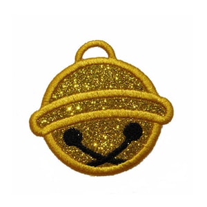 May include: A gold glitter Christmas bell ornament with a black smiling face.