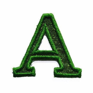 Peut inclure: Écusson brodé vert en forme de lettre "A" avec une texture pailletée. Le patch présente une police de caractères classique avec empattements et est conçu pour être appliqué sur des vêtements ou des accessoires. La lettre est soulignée d'un fil vert plus foncé.