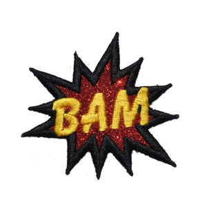 May include: A red and black glitter iron-on patch with the word "BAM" in yellow letters.