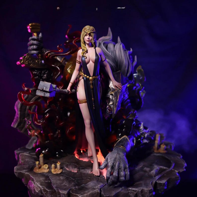 May include: A detailed figurine of a woman in a black dress with gold accents, holding a hammer. She stands before a large, armored figure with a gray mane. The base is a rocky surface with red and gold accents.