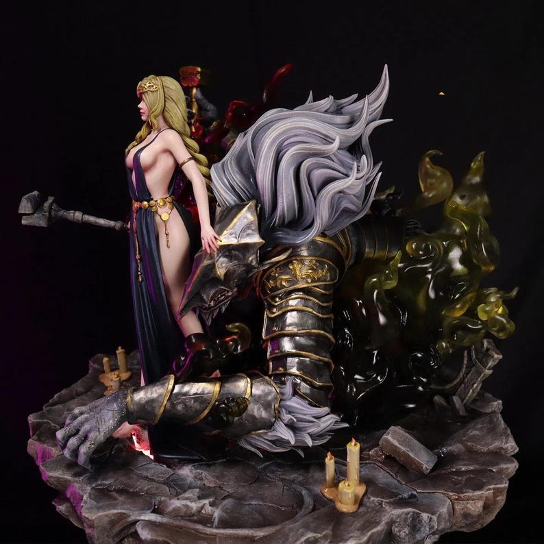 May include: A detailed figurine depicting a fantasy scene. A woman in a dark blue dress stands beside a kneeling armored figure with long, flowing white hair. The base features candles and a rocky texture, with green and red smoky effects.