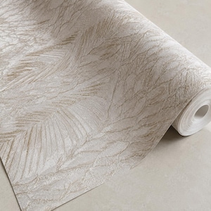 May include: A roll of wallpaper featuring a textured, off-white and light beige surface with a repeating pattern of organic, leaf-like shapes. The design has a subtle metallic sheen and a raised, tactile finish across the entire paper surface.