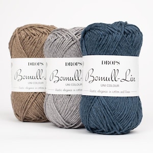 May include: Three skeins of Drops Bomull-Lin yarn in shades of brown, gray, and blue. Each skein has a white label with the brand name and product details. The yarn is labeled as "Rustic elegance in cotton and linen."