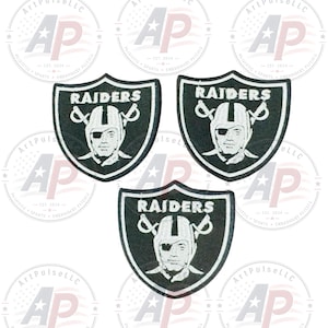 May include: Three embroidered patches featuring the Raiders logo, which consists of a black shield shape with a white border, the word RAIDERS in white text, and a central illustration of a football player wearing a helmet and an eye patch.