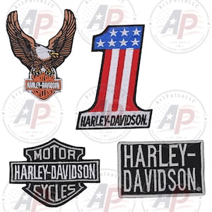 May include: Four embroidered Harley-Davidson patches. One features an eagle above a logo, one is a number one with stars and stripes, one is a shield-shaped logo with text, and one is a rectangular patch with the brand name in white lettering.