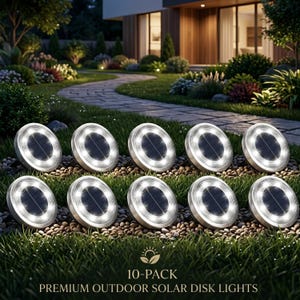 May include: Ten premium outdoor solar disk lights are arranged on a bed of small stones and grass. Each light has a circular design with a bright white LED ring and a dark solar panel center. The text "10-PACK" and "PREMIUM OUTDOOR SOLAR DISK LIGHTS" is visible.