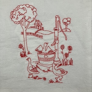 May include: Red embroidered design on a white fabric background. The design features a well with a bucket, a tree, a house, and three ducks. The ducks are near the well and the house is in the background.
