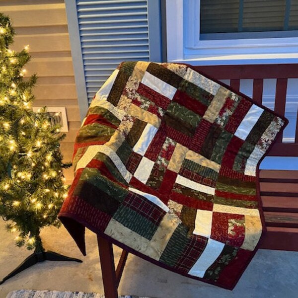 Red, burgundy and sage green Christmas table quilt or throw, Cotton. Polyester/cotton batting. Machine pieced and quilted. Farmhouse quilt.