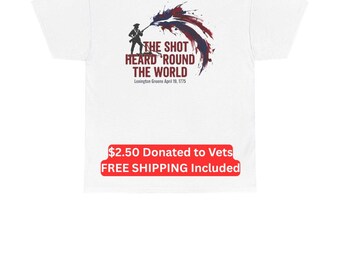 Puede incluir: Una camiseta blanca con un gráfico en la espalda que muestra la silueta de un soldado sosteniendo un mosquete. El diseño incluye efectos de salpicaduras de pintura roja y azul y el texto: THE SHOT HEARD ROUND THE WORLD Lexington Greene April 19, 1775.