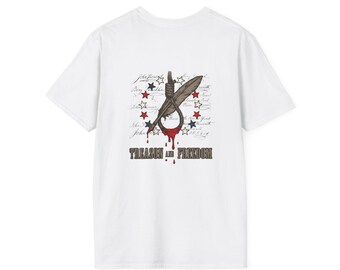 May include: A white t-shirt featuring a graphic design of a noose and a quill pen. The design includes red and blue stars, script text, and red drips resembling blood. Below the graphic, the text reads TREASON AND FREEDOM in bold letters.